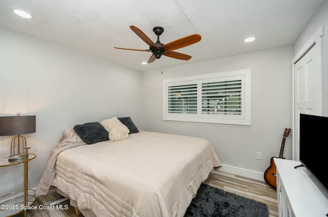 bedroom with ceiling fan and light hardwood / wood-style flooring