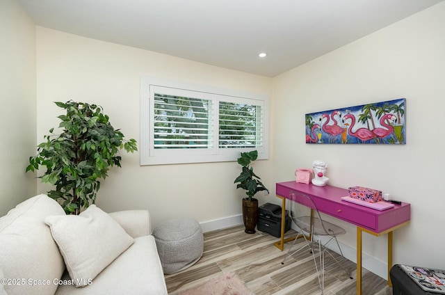 home office with light hardwood / wood-style floors