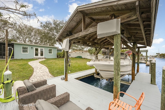 view of dock featuring a lawn and a water view