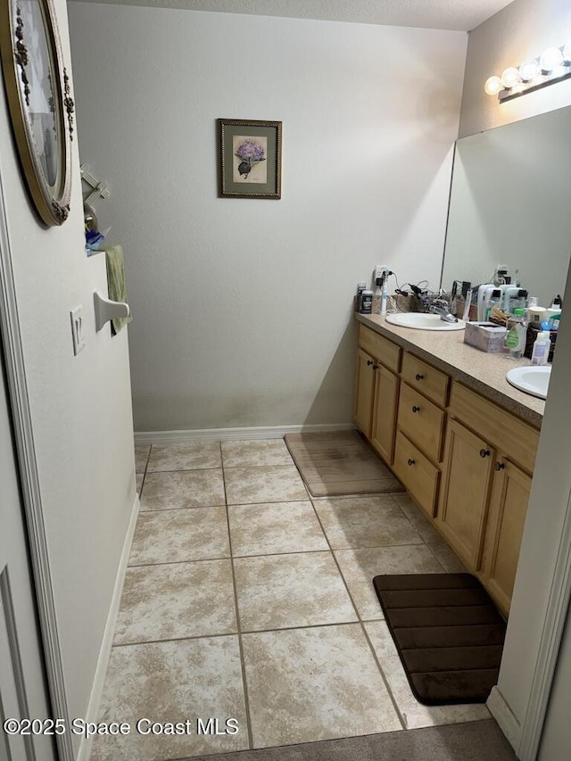 bathroom with tile patterned floors and vanity