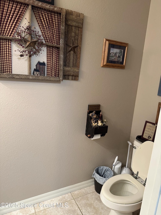 bathroom featuring toilet and tile patterned flooring