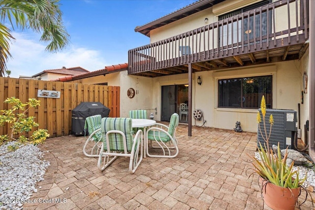 view of patio / terrace featuring a balcony, cooling unit, and grilling area