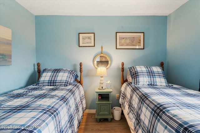 bedroom with dark hardwood / wood-style flooring