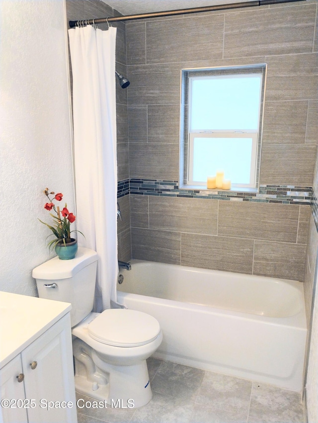 full bathroom featuring toilet, vanity, tile patterned floors, and shower / bath combo