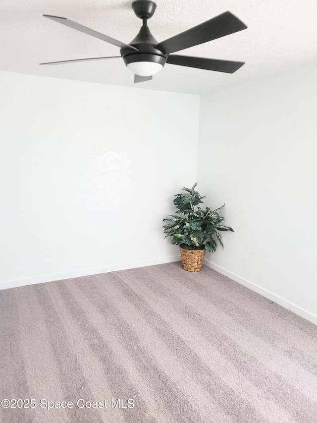 empty room featuring ceiling fan and carpet flooring