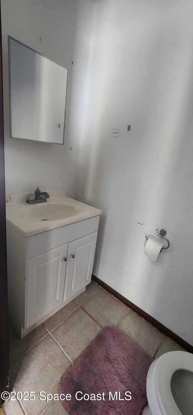 bathroom with tile patterned floors and vanity