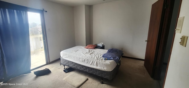 bedroom with light colored carpet and access to outside