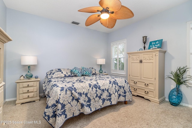 bedroom with ceiling fan and light colored carpet