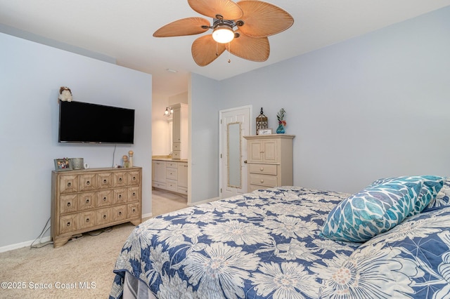 carpeted bedroom with ceiling fan and ensuite bathroom