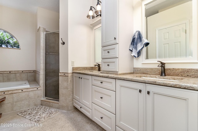 bathroom featuring vanity and shower with separate bathtub