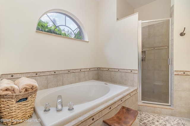 bathroom featuring independent shower and bath