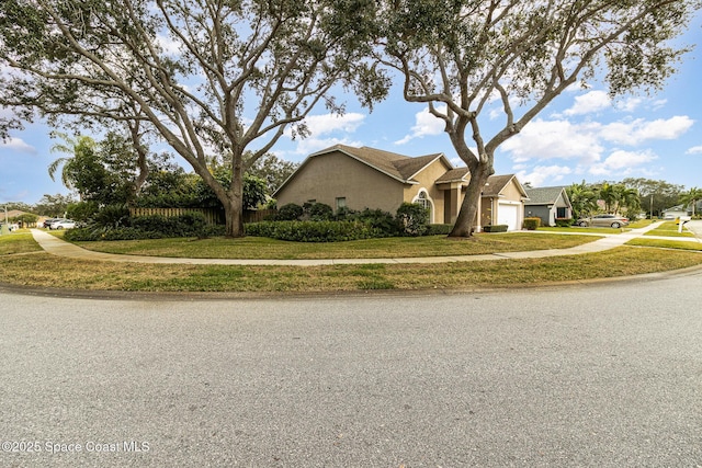 view of front of house featuring a front lawn and a garage