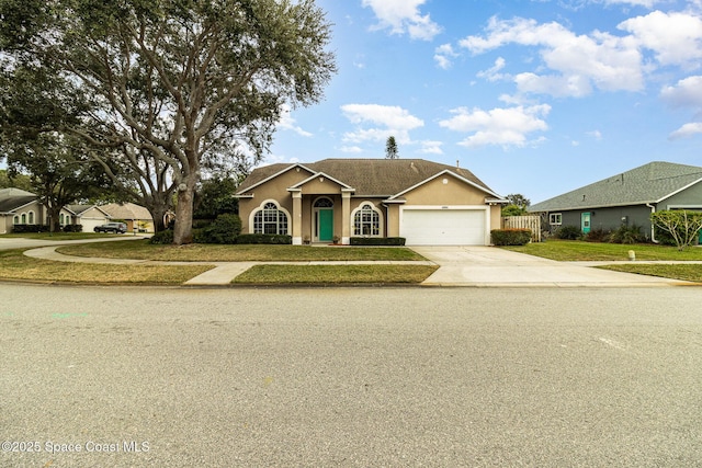 single story home featuring a front lawn and a garage