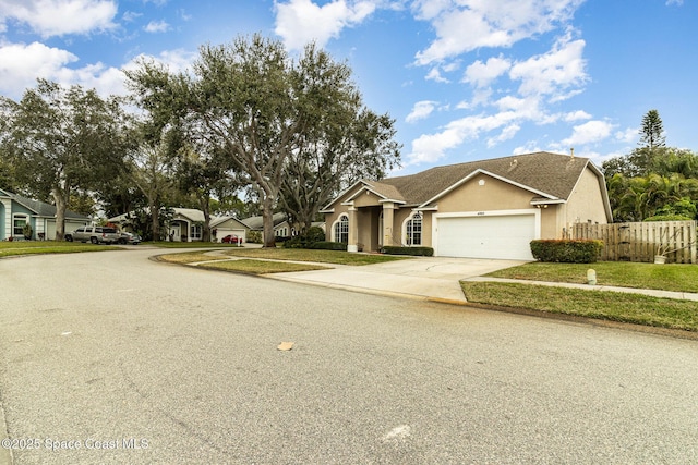 single story home featuring a front yard and a garage