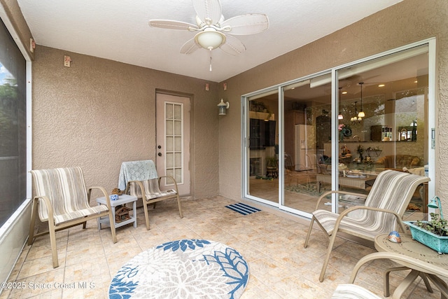 sunroom / solarium with ceiling fan