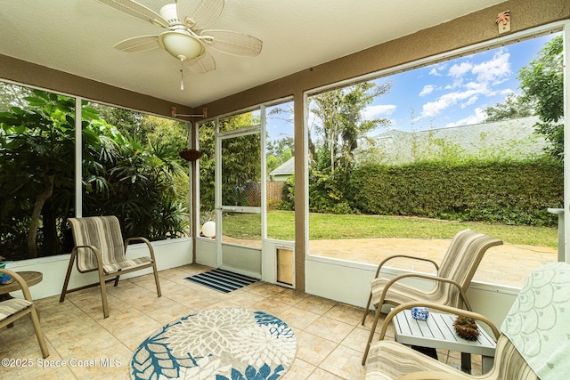 sunroom / solarium featuring ceiling fan and plenty of natural light