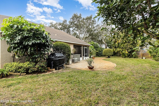 view of yard featuring a sunroom and a patio