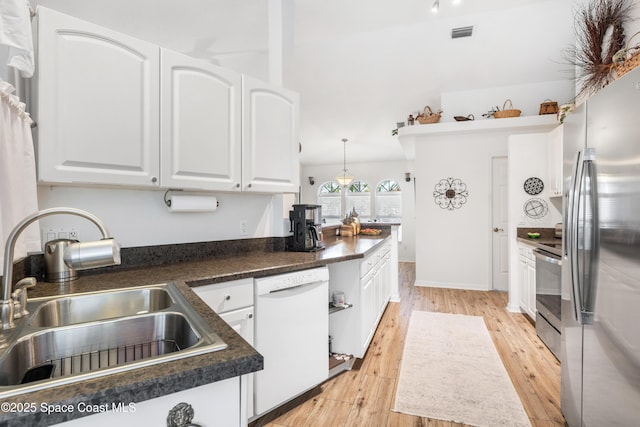 kitchen with white cabinetry, sink, stainless steel appliances, and light wood-type flooring