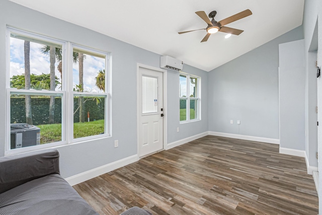 entrance foyer with dark wood-type flooring, ceiling fan, vaulted ceiling, and a wall mounted air conditioner