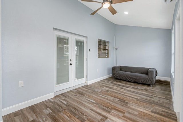 sitting room with ceiling fan, french doors, hardwood / wood-style floors, and high vaulted ceiling