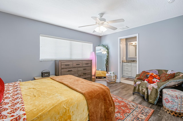 bedroom with ceiling fan, hardwood / wood-style floors, and ensuite bathroom