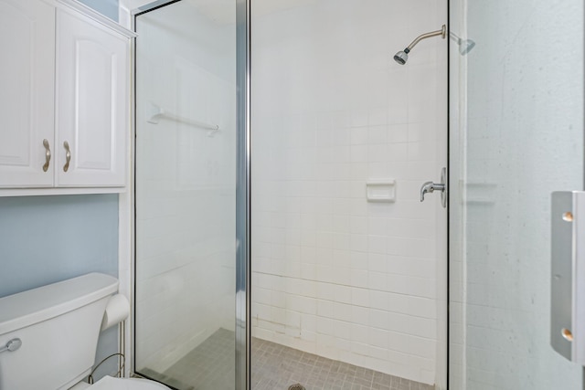 bathroom featuring toilet and walk in shower