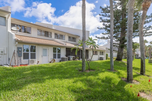 exterior space with a front yard and central air condition unit