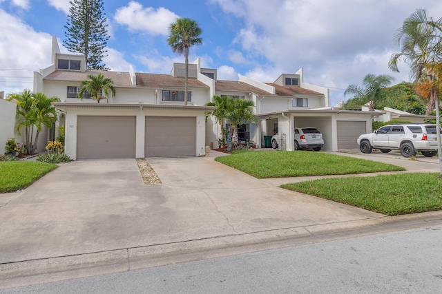 view of front of property featuring a front yard and a garage