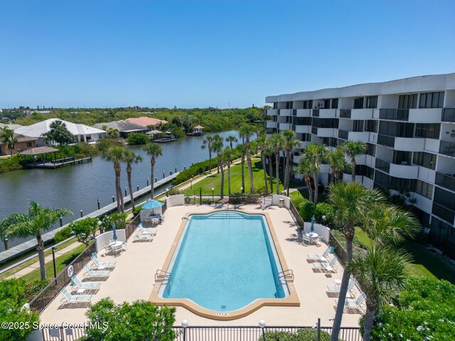 view of swimming pool featuring a patio area and a water view