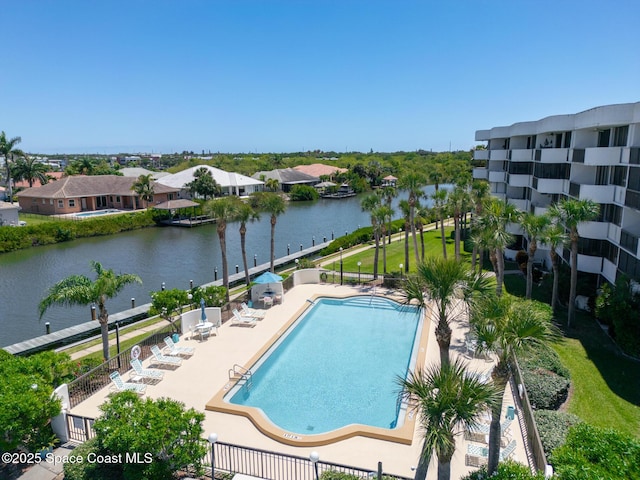 view of swimming pool featuring a patio area and a water view