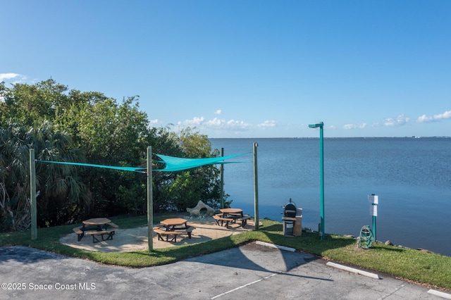 property view of water featuring an outdoor fire pit