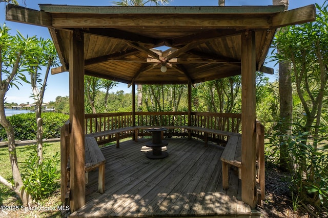 wooden deck with a water view and a gazebo