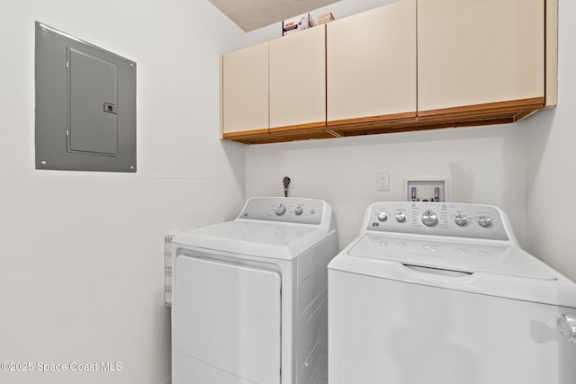 laundry area with a textured ceiling, electric panel, cabinets, and washing machine and dryer