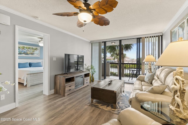 living room featuring hardwood / wood-style flooring, expansive windows, crown molding, and a textured ceiling