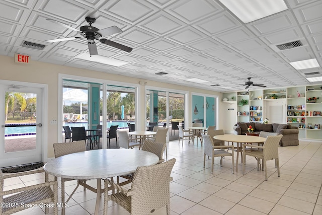 sunroom featuring ceiling fan and a healthy amount of sunlight