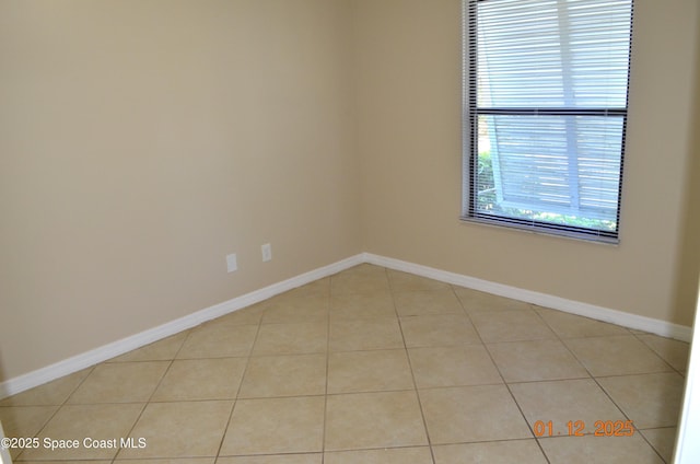 unfurnished room featuring light tile patterned flooring