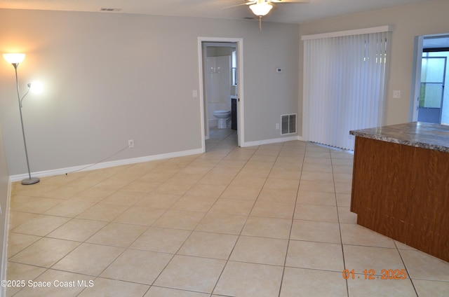 tiled empty room with ceiling fan