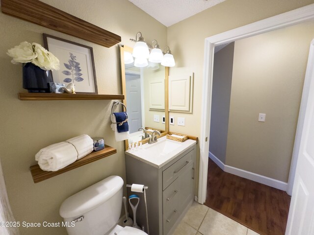 bathroom with vanity, tile patterned flooring, and toilet