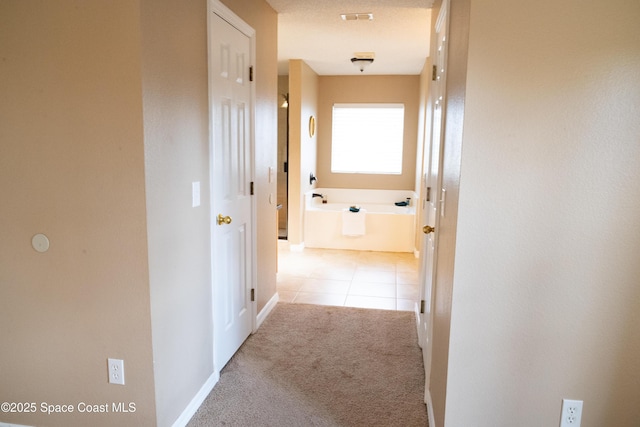 corridor featuring light tile patterned floors