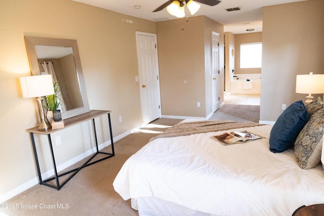 carpeted bedroom featuring ceiling fan and ensuite bath