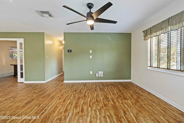 spare room featuring hardwood / wood-style flooring and ceiling fan