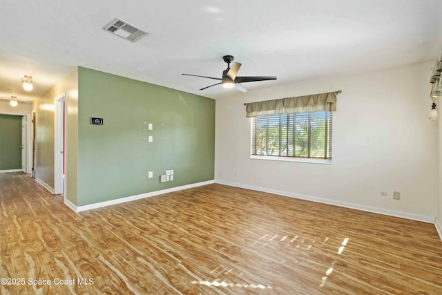 spare room featuring wood-type flooring and ceiling fan