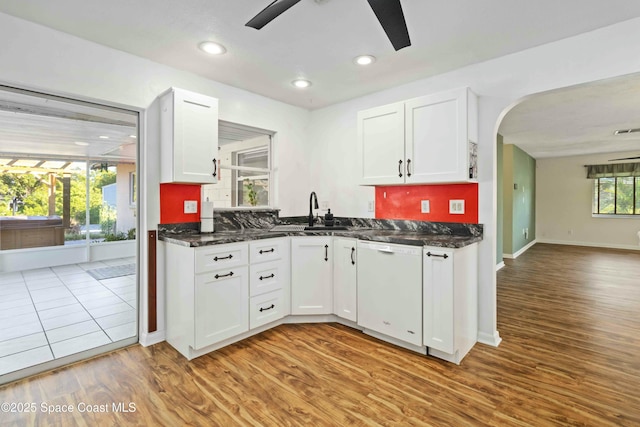 kitchen featuring sink, white cabinetry, and white dishwasher