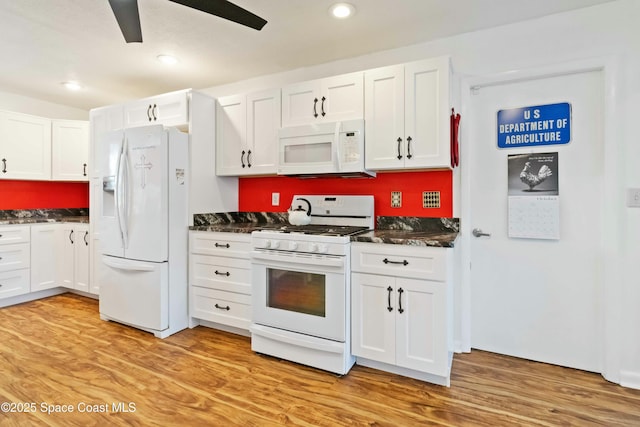 kitchen with white appliances, light hardwood / wood-style flooring, and white cabinets