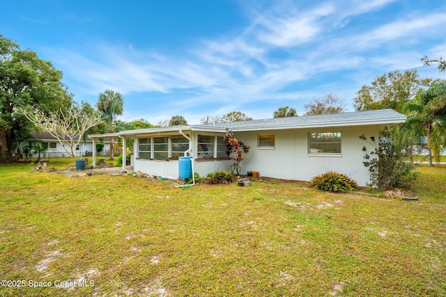 view of front of house featuring a front lawn and a sunroom