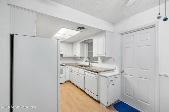 kitchen featuring white cabinets, light wood-type flooring, sink, and white appliances