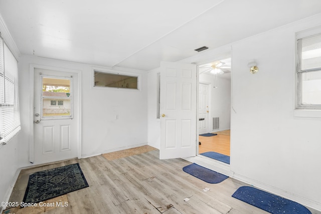 foyer with ceiling fan and light hardwood / wood-style flooring