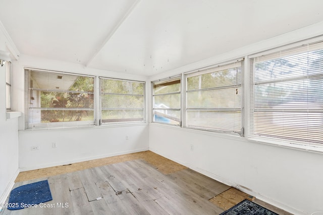 unfurnished sunroom with lofted ceiling and a healthy amount of sunlight