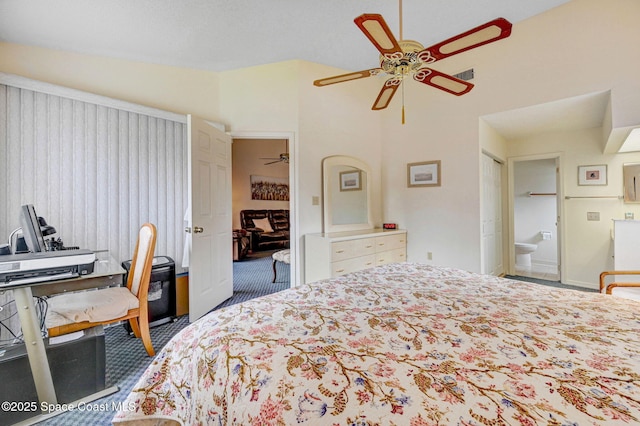 carpeted bedroom featuring lofted ceiling, ensuite bathroom, and ceiling fan