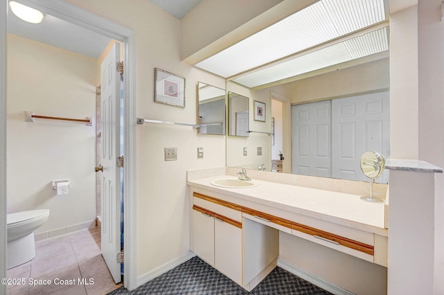 bathroom featuring toilet, tile patterned flooring, and sink